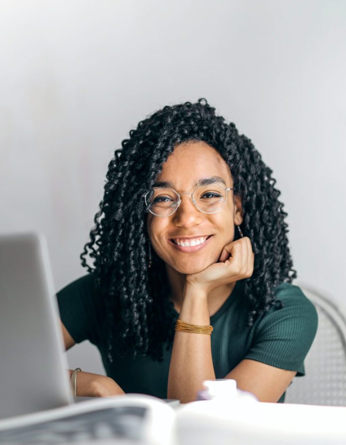 happy-ethnic-woman-sitting-at-table-with-laptop-3769021.jpg